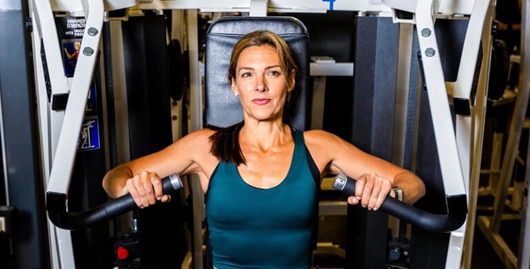 Worldgate Woman doing Chest Press on Machine